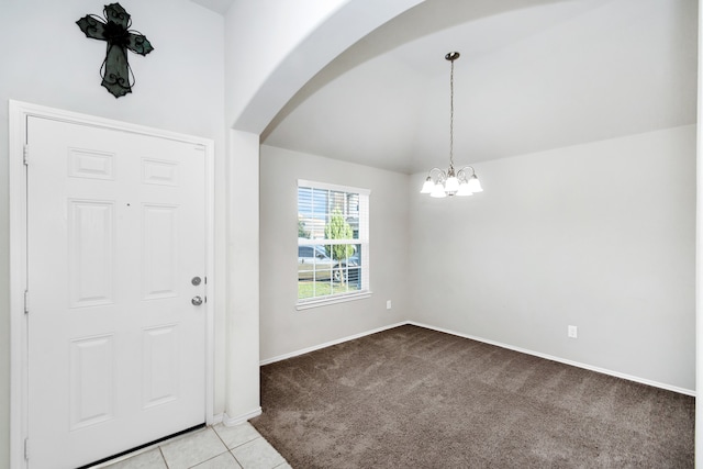 entrance foyer featuring a notable chandelier, light carpet, and lofted ceiling