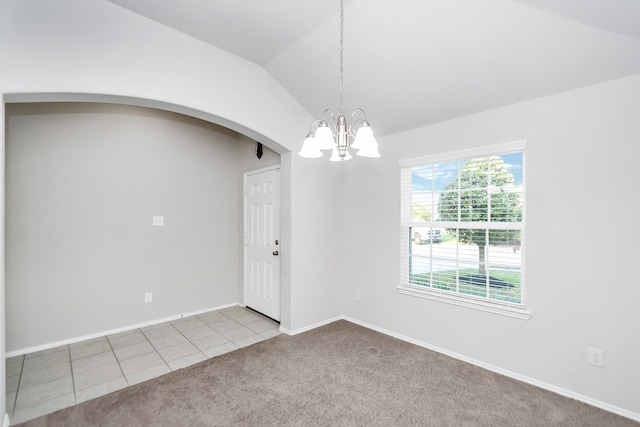 unfurnished room featuring light colored carpet, a notable chandelier, and vaulted ceiling