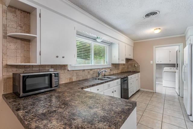 kitchen with sink, decorative backsplash, washer / clothes dryer, white cabinets, and dishwasher