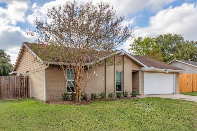 ranch-style home featuring a front lawn and a garage