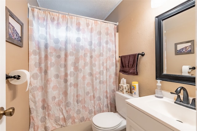 full bathroom with vanity, shower / bath combo, a textured ceiling, and toilet