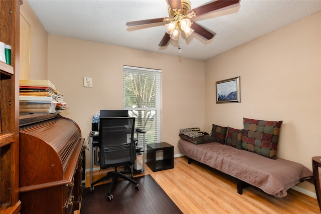 home office with hardwood / wood-style floors and ceiling fan