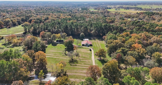 drone / aerial view featuring a rural view and a view of trees