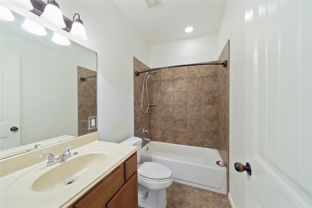 full bathroom featuring tile patterned floors, vanity, tiled shower / bath combo, and toilet