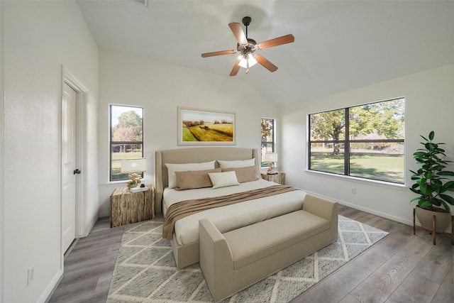 bedroom featuring light hardwood / wood-style flooring, multiple windows, and ceiling fan