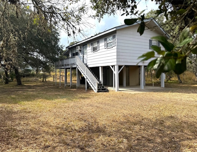 back of property featuring a wooden deck and a patio