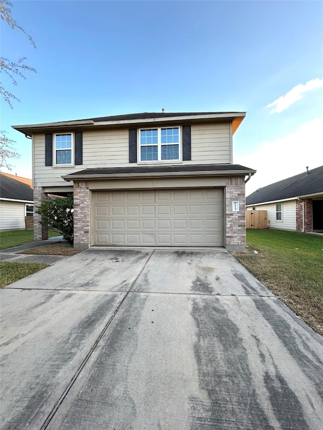 front facade featuring a garage and a front yard