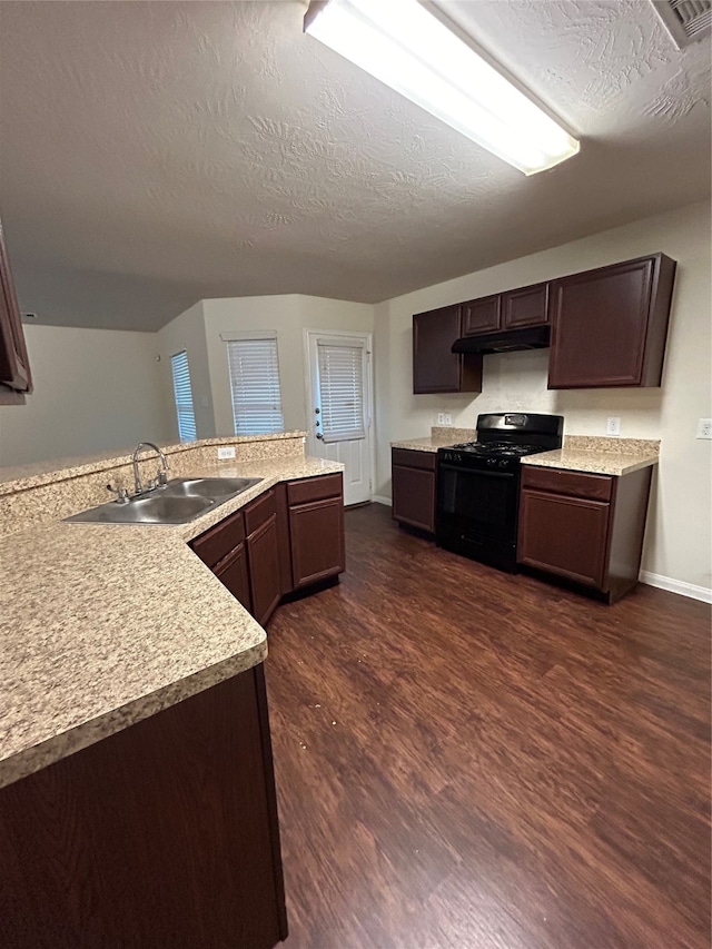 kitchen featuring a textured ceiling, dark hardwood / wood-style flooring, sink, and gas stove