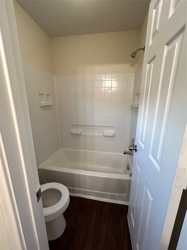 bathroom with hardwood / wood-style flooring, toilet, and shower / bathtub combination