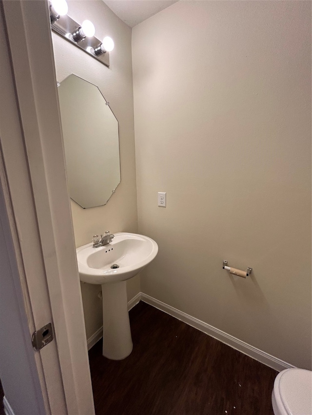 bathroom with toilet and hardwood / wood-style flooring