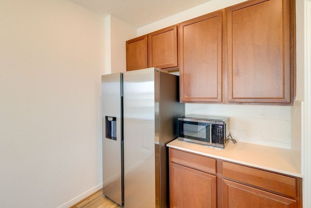 kitchen with light wood-type flooring and stainless steel appliances