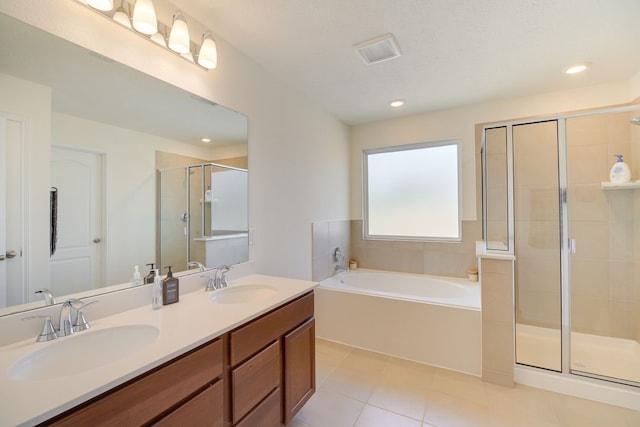 bathroom featuring vanity, tile patterned floors, and separate shower and tub