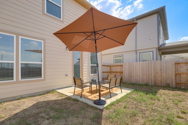 back of house featuring a patio area and a lawn