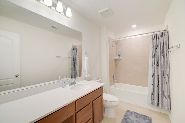 full bathroom with a textured ceiling, shower / tub combo with curtain, vanity, tile patterned floors, and toilet