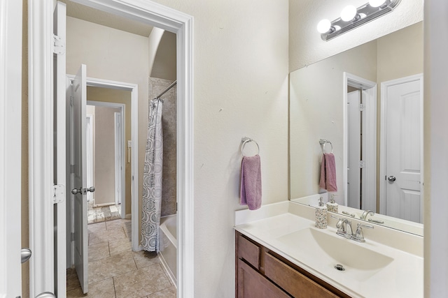 bathroom with shower / tub combo with curtain, vanity, and tile patterned flooring