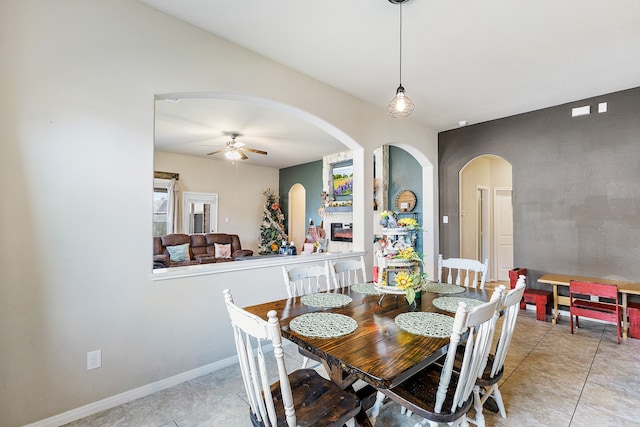 tiled dining room with ceiling fan