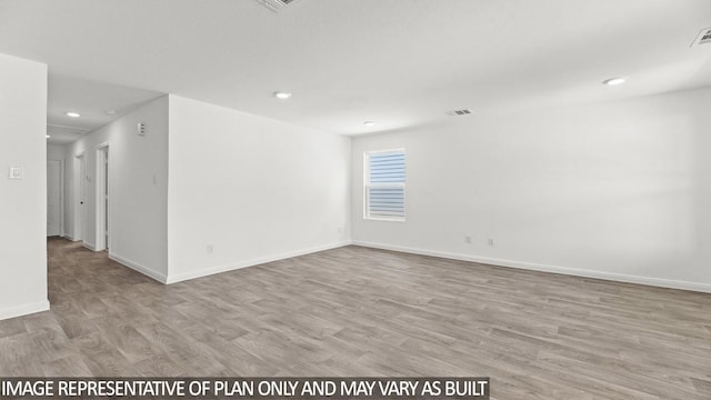 unfurnished room with light wood-type flooring