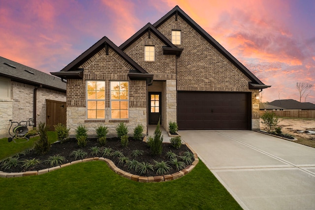 view of front of property featuring a garage and a yard