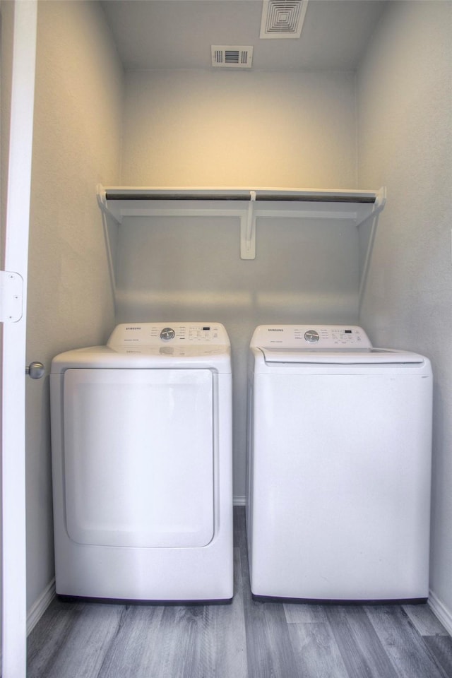 4 Big Lake Cir, Huntsville, TX 77320 - laundry area with washing machine and dryer, wood finished floors, and baseboards