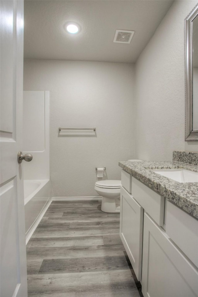 4 Big Lake Cir, Huntsville, TX 77320 - full bathroom with toilet, baseboards, vanity, recessed lighting, and wood finished floors