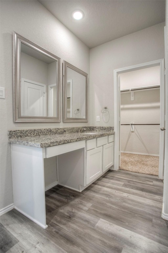 bathroom with vanity and hardwood / wood-style flooring