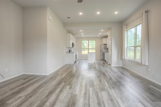 4 Big Lake Cir, Huntsville, TX 77320 - unfurnished living room featuring light wood-type flooring, recessed lighting, and baseboards