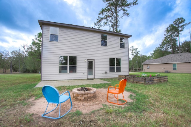 back of property featuring a lawn and a fire pit