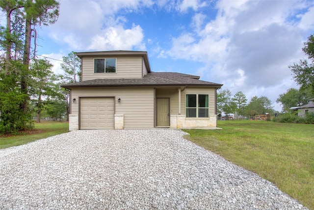 view of front of property featuring a front yard and a garage