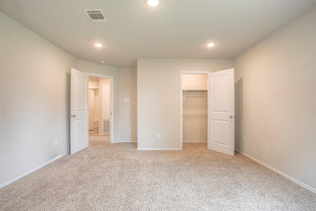 4 Big Lake Cir, Huntsville, TX 77320 - unfurnished bedroom with recessed lighting, light colored carpet, a walk in closet, and baseboards