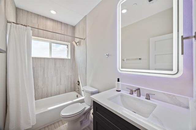 full bathroom with toilet, shower / bath combo, and vanity