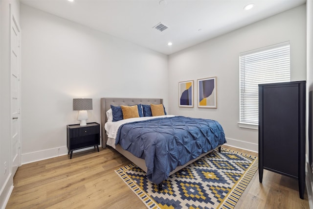 bedroom with hardwood / wood-style flooring