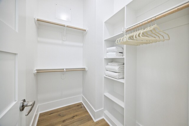 walk in closet with hardwood / wood-style floors