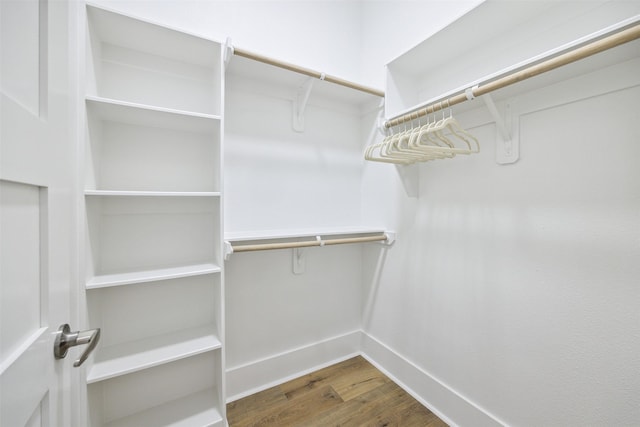 bedroom with connected bathroom and light hardwood / wood-style floors