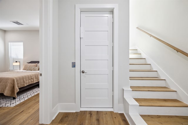 stairs with hardwood / wood-style flooring