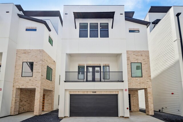 view of front of property with a garage and a balcony