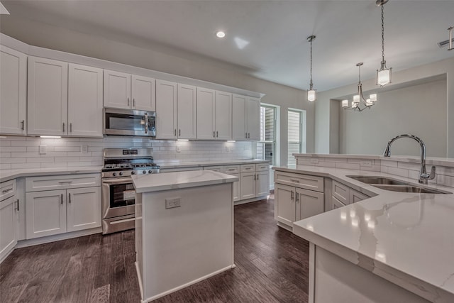 kitchen featuring white cabinets, appliances with stainless steel finishes, and sink