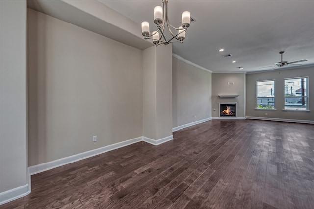 unfurnished living room featuring dark hardwood / wood-style floors, ceiling fan with notable chandelier, and ornamental molding