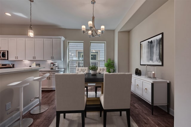 dining room featuring dark wood-type flooring and a notable chandelier