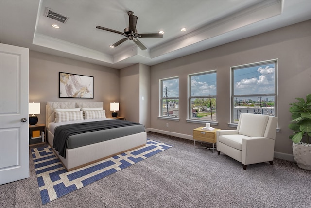 carpeted bedroom with ornamental molding, ceiling fan, and a tray ceiling