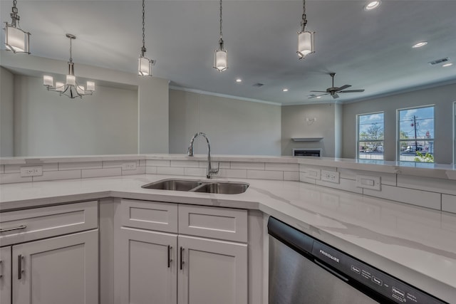 kitchen featuring white cabinetry, sink, light stone counters, hanging light fixtures, and dishwasher