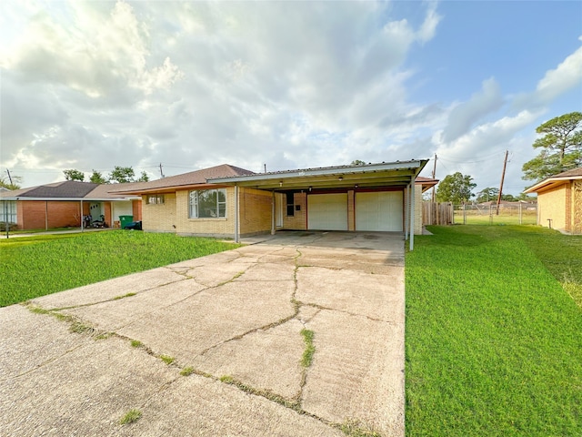 single story home with a garage, a carport, and a front lawn