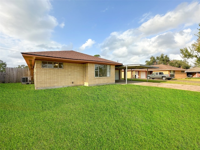 back of house with a lawn, cooling unit, and a carport