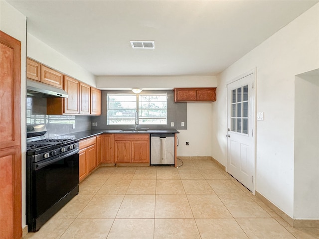 kitchen featuring dishwasher, black range with gas stovetop, sink, and light tile patterned floors