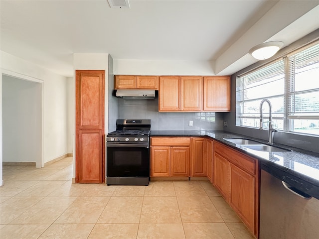 kitchen featuring tasteful backsplash, appliances with stainless steel finishes, sink, and light tile patterned floors