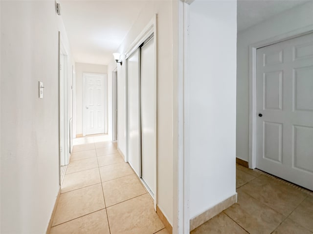 hallway featuring light tile patterned flooring