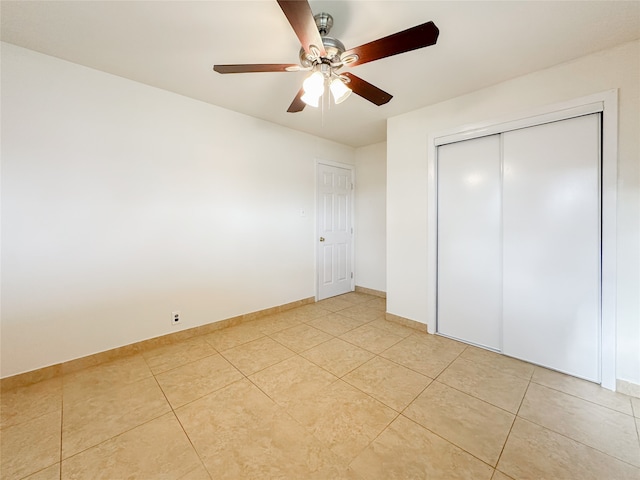 unfurnished bedroom with a closet, light tile patterned floors, and ceiling fan