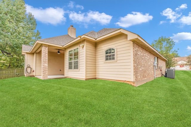 back of house with a lawn, central air condition unit, and ceiling fan