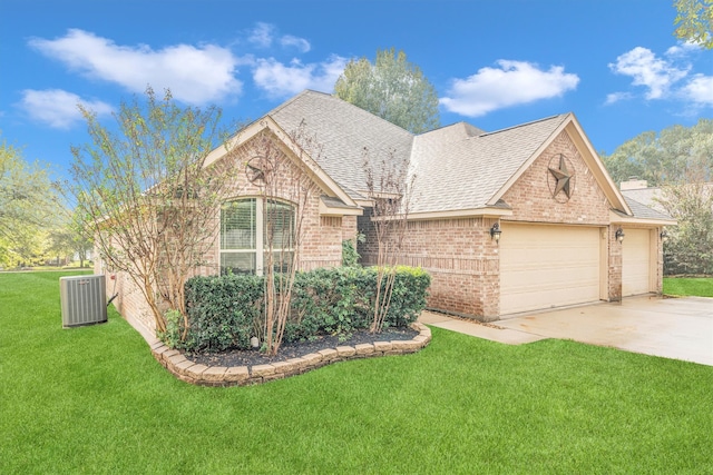 view of front of property with a garage, central air condition unit, and a front yard