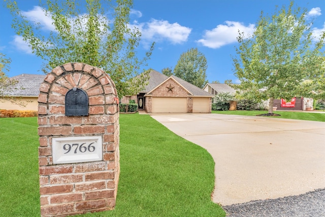 view of front of home with a garage and a front lawn