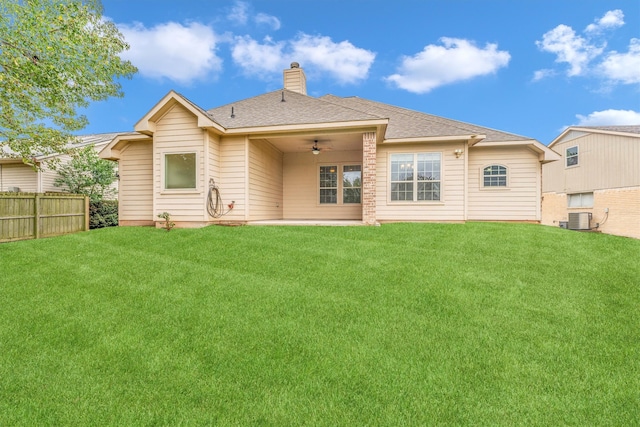 back of house featuring ceiling fan, central AC, and a yard